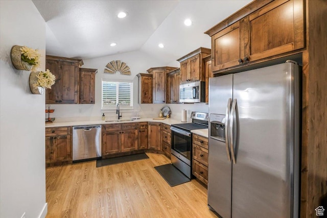 591 S Lakeside Dr, Franklin, ID 83237 - kitchen with vaulted ceiling, a sink, light countertops, light wood finished floors, and stainless steel appliances