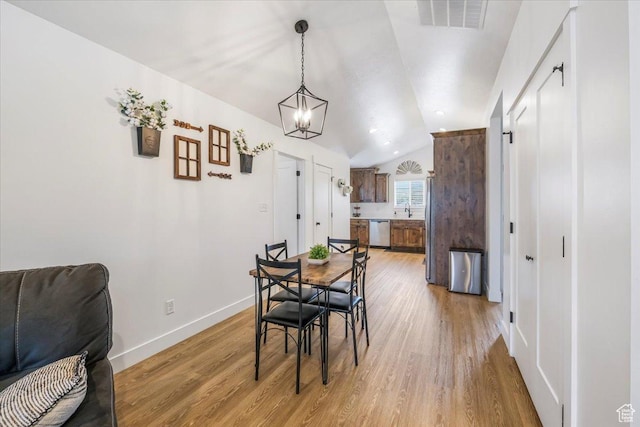 591 S Lakeside Dr, Franklin, ID 83237 - dining space featuring visible vents, lofted ceiling, baseboards, light wood-style floors, and a chandelier