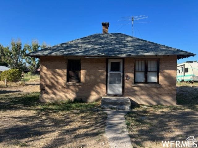 390 W Sandy Ln, Salina, UT 84654 - bungalow-style house featuring a shingled roof and a chimney