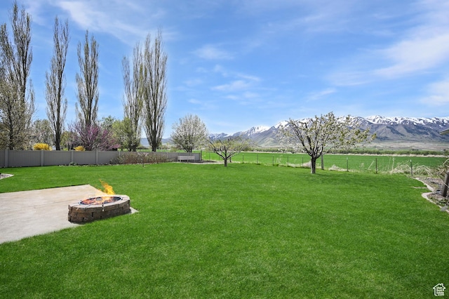 633 N 800 E, Wellsville, UT 84339 - view of yard featuring fence private yard, a fire pit, a mountain view, and a patio area