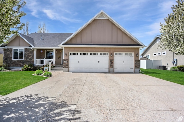 633 N 800 E, Wellsville, UT 84339 - craftsman inspired home with a garage, a front lawn, stone siding, board and batten siding, and driveway