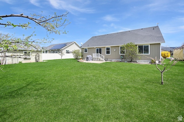 633 N 800 E, Wellsville, UT 84339 - back of property with fence, a lawn, a patio area, and roof with shingles