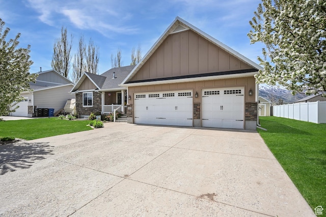 633 N 800 E, Wellsville, UT 84339 - craftsman-style home featuring fence, stone siding, board and batten siding, a front yard, and cooling unit
