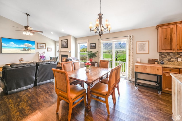 633 N 800 E, Wellsville, UT 84339 - dining space featuring a warm lit fireplace, dark wood-style floors, lofted ceiling, and ceiling fan with notable chandelier