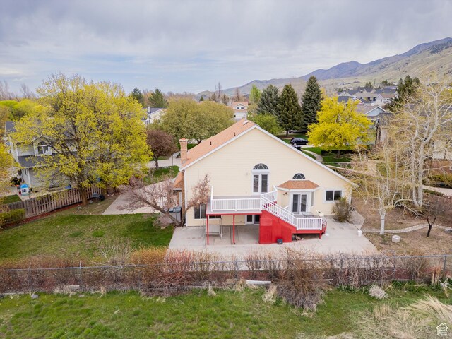 1720 N 1850 E, North Logan, UT 84341 - rear view of house featuring a patio, a fenced backyard, a deck with mountain view, and a chimney