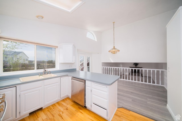 1720 N 1850 E, North Logan, UT 84341 - kitchen featuring a sink, light wood-style flooring, a peninsula, white cabinetry, and stainless steel dishwasher