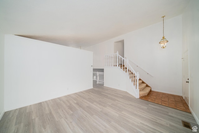 1720 N 1850 E, North Logan, UT 84341 - unfurnished living room featuring visible vents, stairs, light wood-style floors, and baseboards
