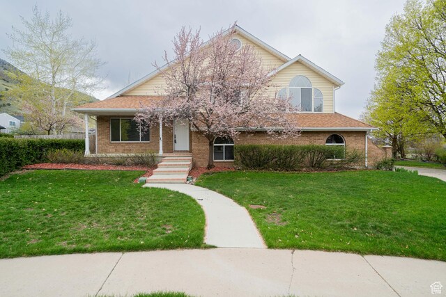 1720 N 1850 E, North Logan, UT 84341 - view of front of home with brick siding and a front yard