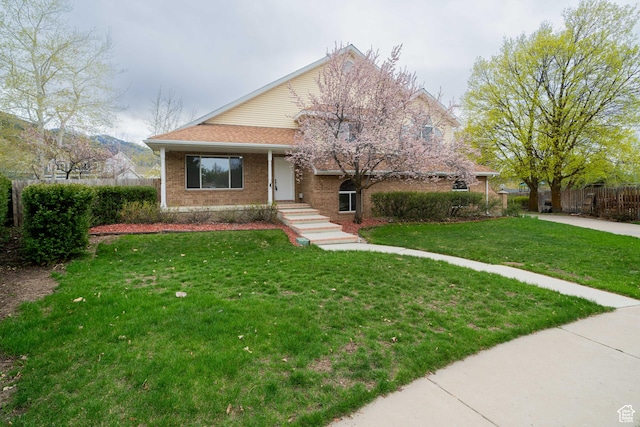 1720 N 1850 E, North Logan, UT 84341 - view of front of property featuring brick siding, fence, and a front yard