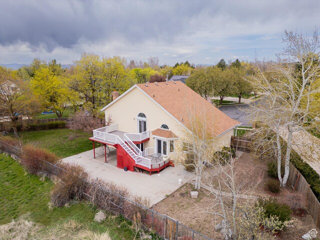 1720 N 1850 E, North Logan, UT 84341 - rear view of property with a chimney, a wooden deck, fence private yard, stairway, and a patio