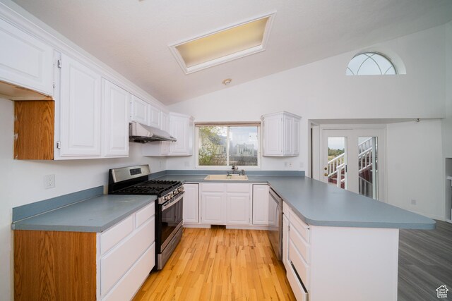 1720 N 1850 E, North Logan, UT 84341 - kitchen featuring appliances with stainless steel finishes, a sink, a peninsula, lofted ceiling, and under cabinet range hood