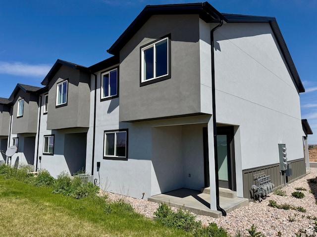 back of house featuring stucco siding