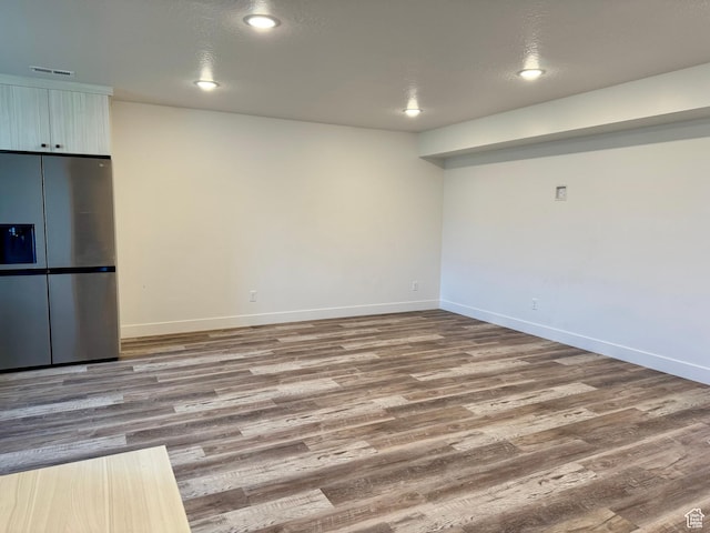 interior space featuring baseboards and wood finished floors