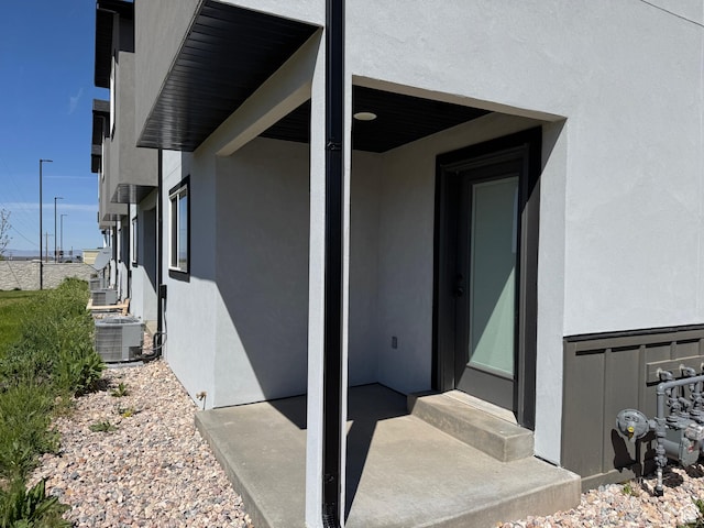 view of property exterior with stucco siding and cooling unit