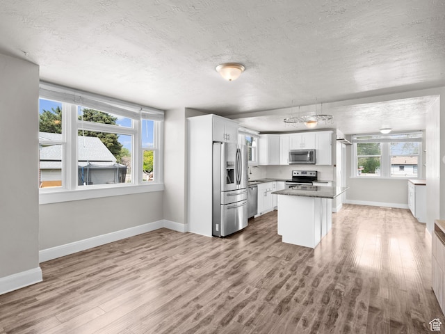 3084 W 3875 S, West Valley City, UT 84119 - kitchen with a textured ceiling, appliances with stainless steel finishes, and light wood-type flooring