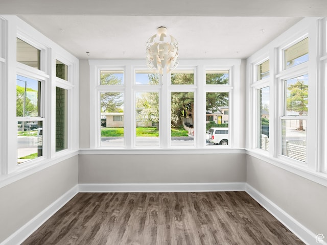 3084 W 3875 S, West Valley City, UT 84119 - unfurnished sunroom featuring an inviting chandelier, baseboards, and wood finished floors