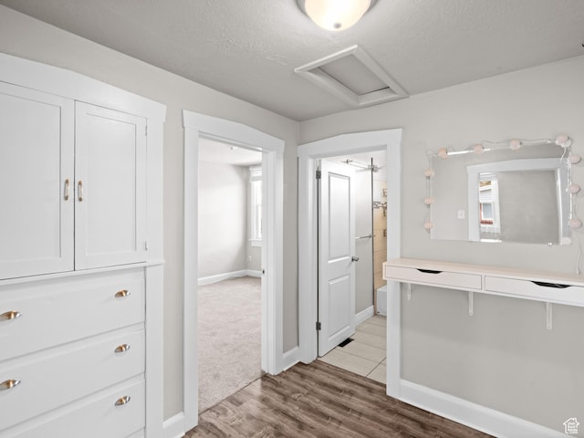 3084 W 3875 S, West Valley City, UT 84119 - corridor with a textured ceiling, baseboards, attic access, and wood finished floors