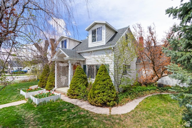 394 W 100 N, Mount Pleasant, UT 84647 - view of front facade with a vegetable garden, a shingled roof, a chimney, and a front lawn