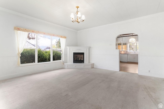 394 W 100 N, Mount Pleasant, UT 84647 - unfurnished living room with an inviting chandelier, ornamental molding, a glass covered fireplace, and carpet flooring
