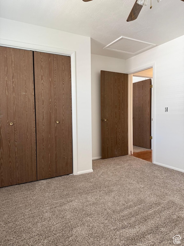 unfurnished bedroom with carpet floors, baseboards, a closet, and ceiling fan