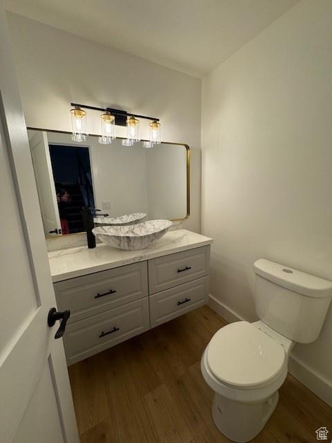 4758 S Ichabod St, Holladay, UT 84117 - half bath featuring vanity, wood finished floors, and toilet