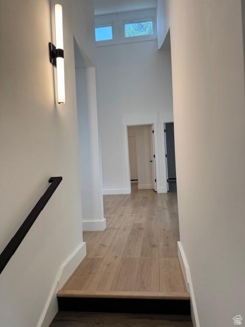 4758 S Ichabod St, Holladay, UT 84117 - stairway featuring baseboards, a high ceiling, and wood finished floors