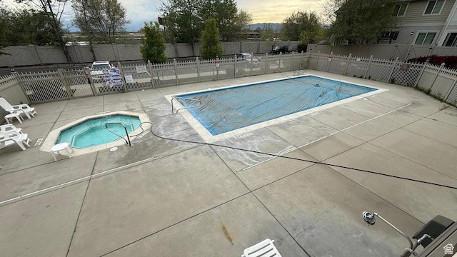1069 N Independence Ave, Provo, UT 84604 - pool at dusk with a community hot tub, a patio, fence, and a community pool