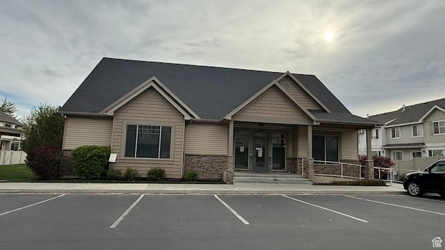 1069 N Independence Ave, Provo, UT 84604 - view of front facade featuring uncovered parking, stone siding, and covered porch