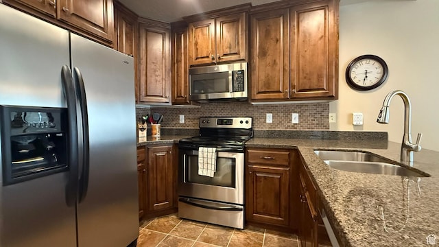 1069 N Independence Ave, Provo, UT 84604 - kitchen with stainless steel appliances, a sink, decorative backsplash, and dark stone counters