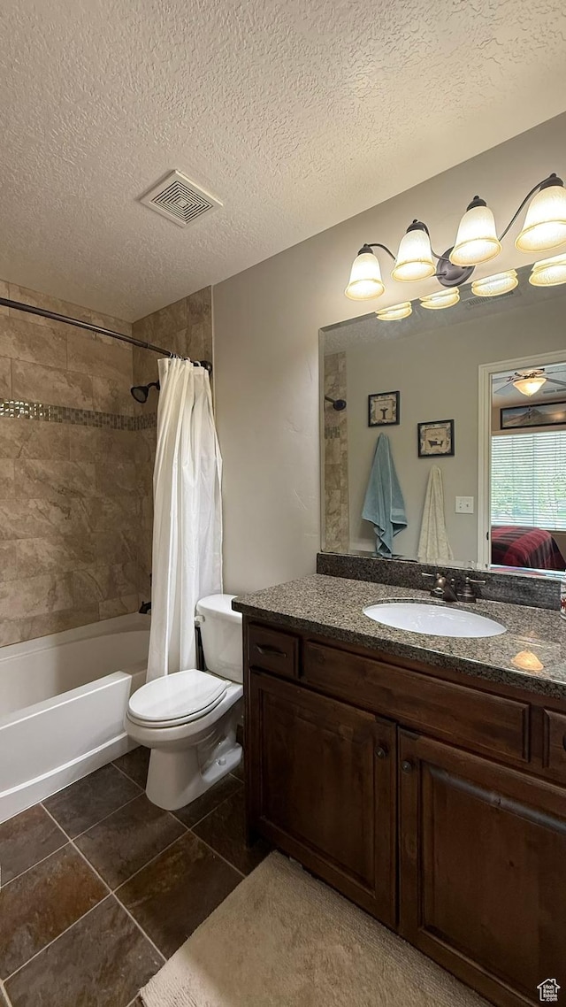 1069 N Independence Ave, Provo, UT 84604 - bathroom featuring toilet, vanity, shower / bath combination with curtain, tile patterned flooring, and a textured ceiling
