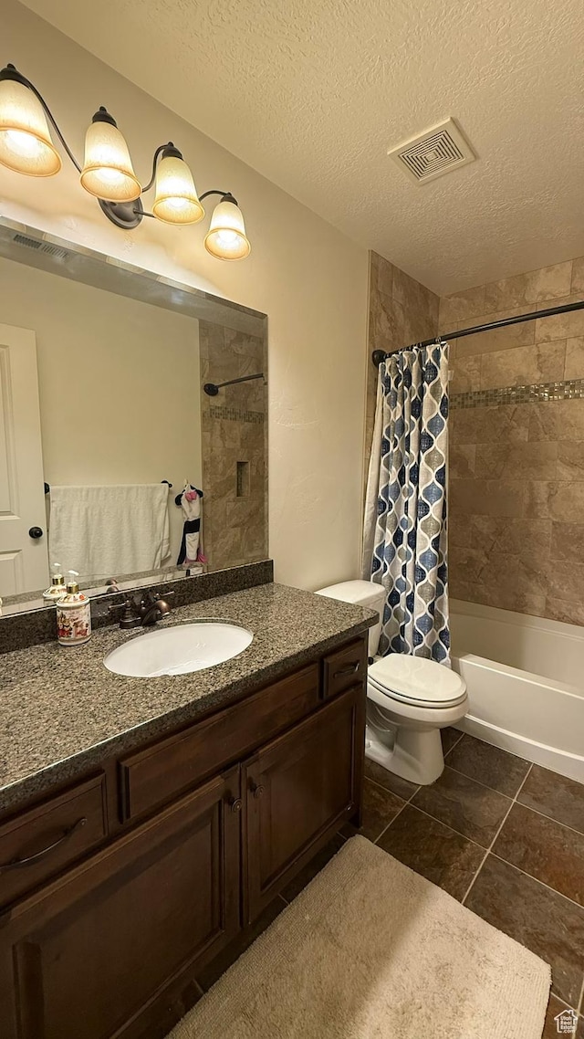 1069 N Independence Ave, Provo, UT 84604 - full bath with vanity, toilet, shower / bath combo with shower curtain, a textured ceiling, and tile patterned floors