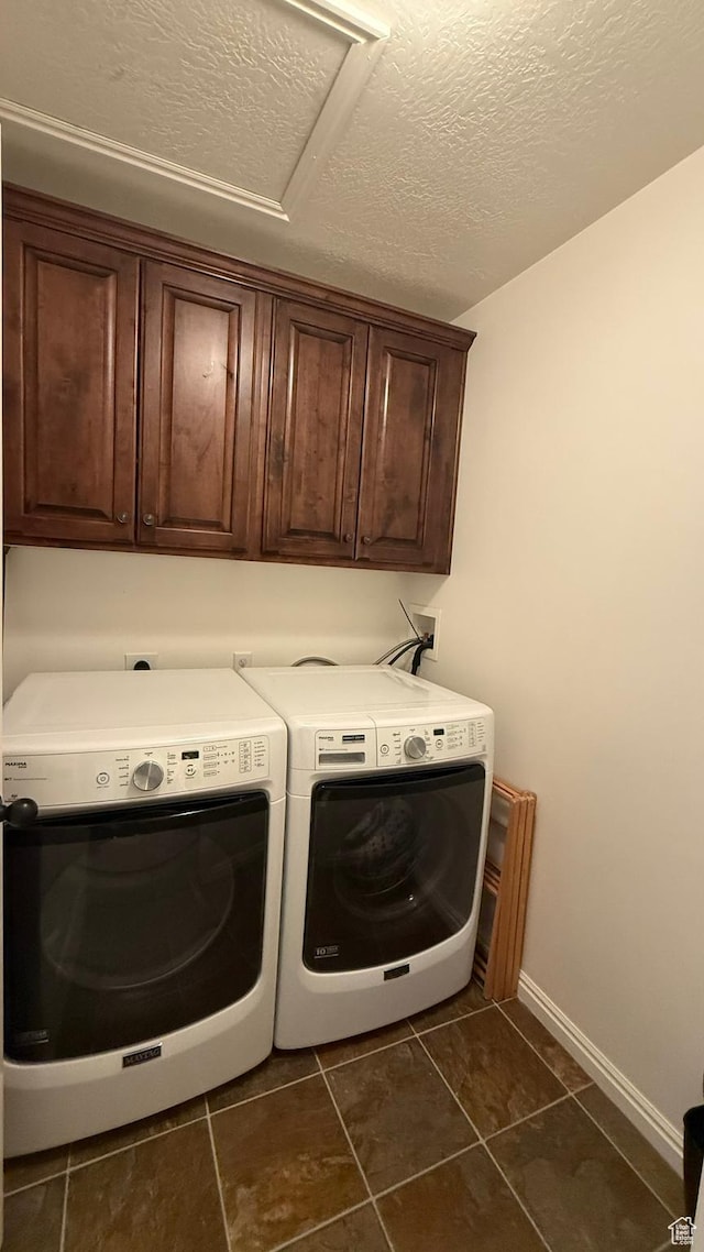 1069 N Independence Ave, Provo, UT 84604 - laundry room featuring cabinet space, independent washer and dryer, dark tile patterned floors, baseboards, and a textured ceiling