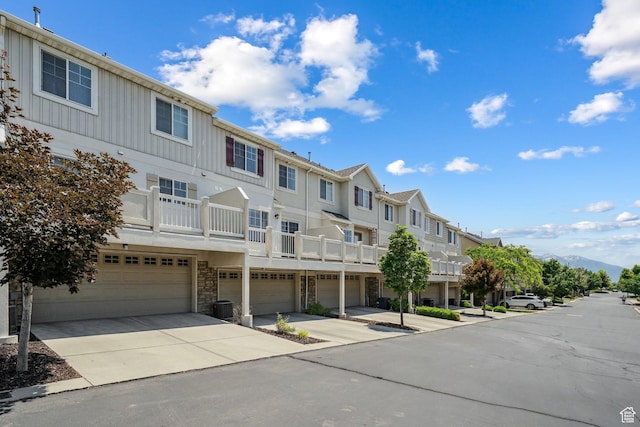 1069 N Independence Ave, Provo, UT 84604 - view of building exterior with a residential view, a garage, concrete driveway, and cooling unit