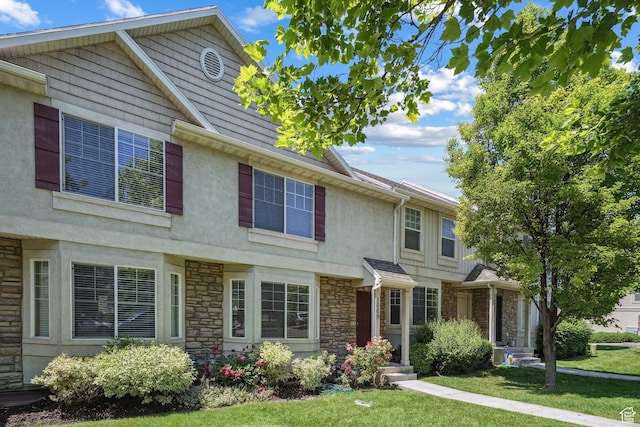 1069 N Independence Ave, Provo, UT 84604 - view of front of house with stone siding, stucco siding, and a front yard