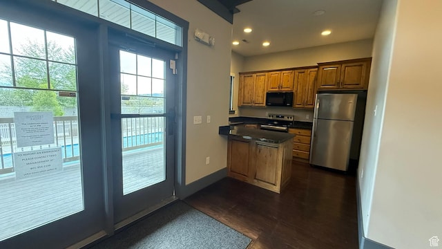 1069 N Independence Ave, Provo, UT 84604 - kitchen featuring stainless steel appliances, a peninsula, dark countertops, recessed lighting, and brown cabinets