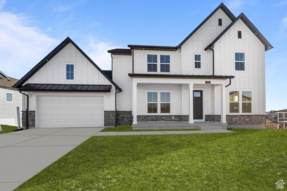 1220 E Hollyhock Way, Layton, UT 84040 - modern inspired farmhouse featuring board and batten siding, stone siding, driveway, and a front yard