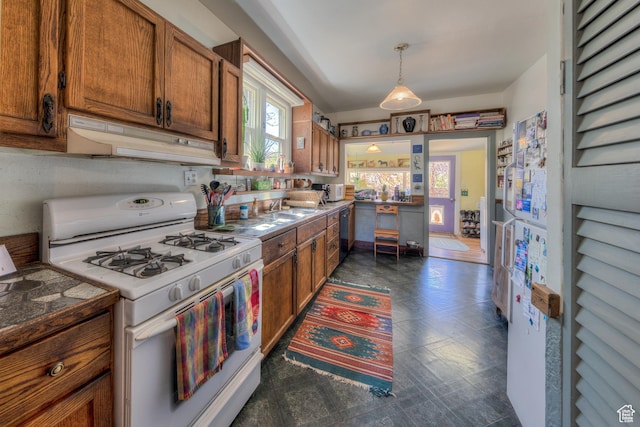210 S 400 E, Moab, UT 84532 - kitchen featuring white range with gas stovetop, under cabinet range hood, brown cabinets, and dishwashing machine
