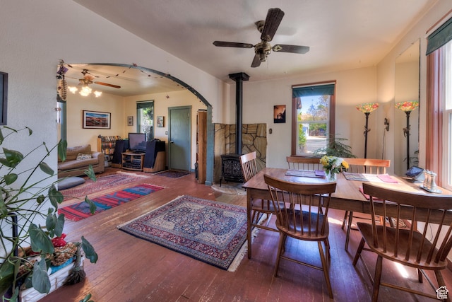 210 S 400 E, Moab, UT 84532 - dining room featuring ceiling fan, a wood stove, hardwood / wood-style floors, and arched walkways