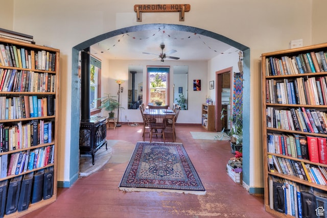 210 S 400 E, Moab, UT 84532 - living area with a wood stove, arched walkways, ceiling fan, and baseboards