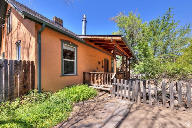 210 S 400 E, Moab, UT 84532 - view of side of property featuring a chimney, fence, and stucco siding