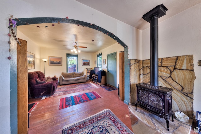 210 S 400 E, Moab, UT 84532 - living area with wood-type flooring, a wood stove, a ceiling fan, and arched walkways