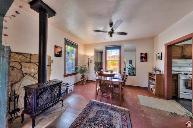 210 S 400 E, Moab, UT 84532 - dining room with a wood stove, hardwood / wood-style floors, ceiling fan, and baseboards