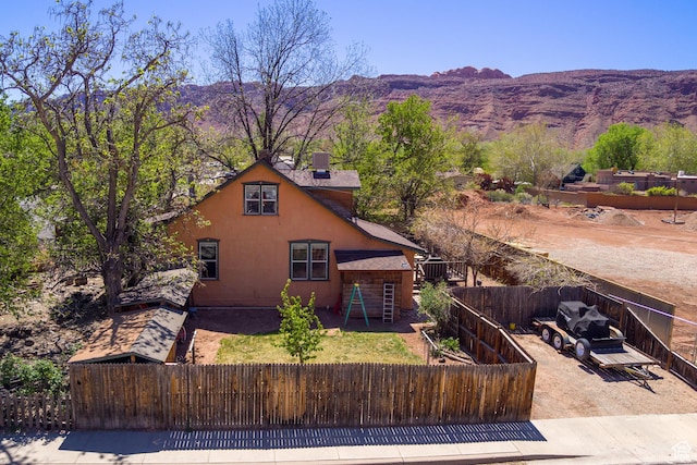 210 S 400 E, Moab, UT 84532 - view of front of property featuring a fenced backyard, a mountain view, and stucco siding