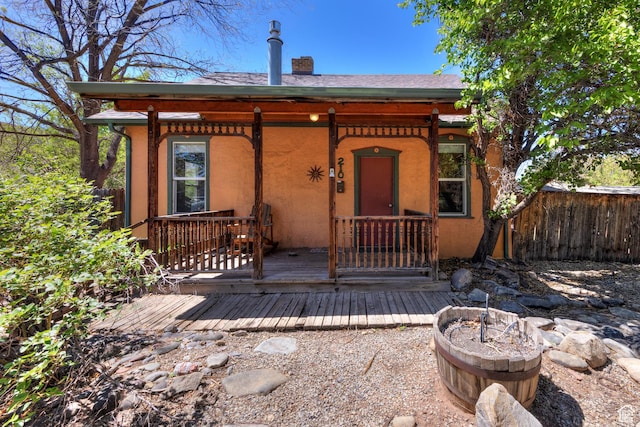 210 S 400 E, Moab, UT 84532 - view of front of property with fence, a chimney, and stucco siding