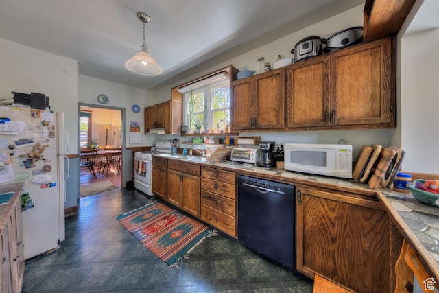 210 S 400 E, Moab, UT 84532 - kitchen with white appliances, healthy amount of natural light, brown cabinetry, and hanging light fixtures