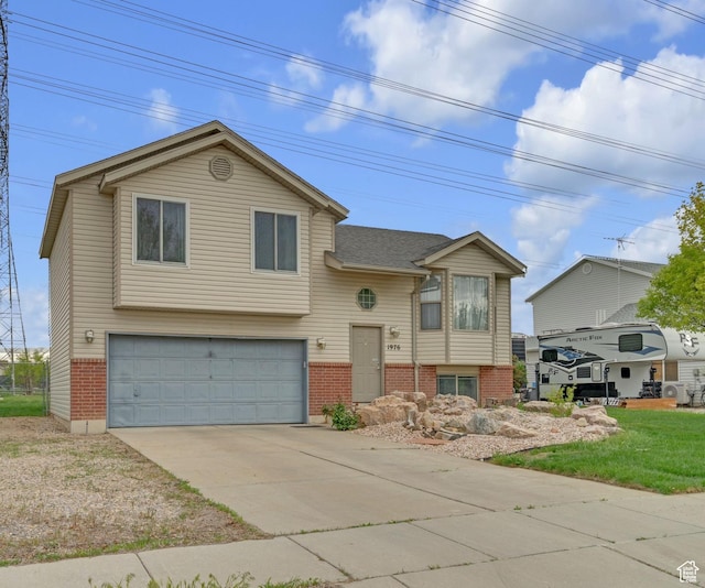 1976 N 1720 W, Clinton, UT 84015 - split foyer home with a garage, concrete driveway, and brick siding