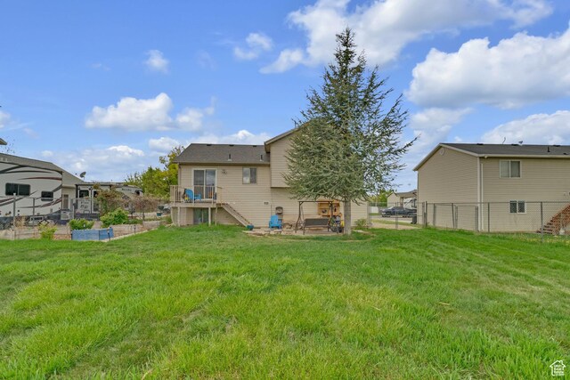 1976 N 1720 W, Clinton, UT 84015 - back of property featuring a garden, a lawn, a wooden deck, stairway, and fence