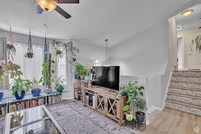 1976 N 1720 W, Clinton, UT 84015 - living room featuring ceiling fan, a textured ceiling, wood finished floors, stairway, and baseboards