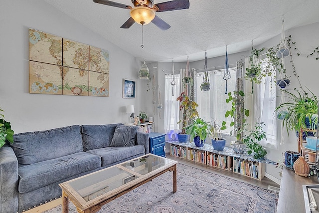 1976 N 1720 W, Clinton, UT 84015 - living area with a textured ceiling, ceiling fan, and wood finished floors