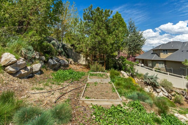 11362 Palisade View Dr, South Jordan, UT 84095 - view of yard featuring a garden and fence